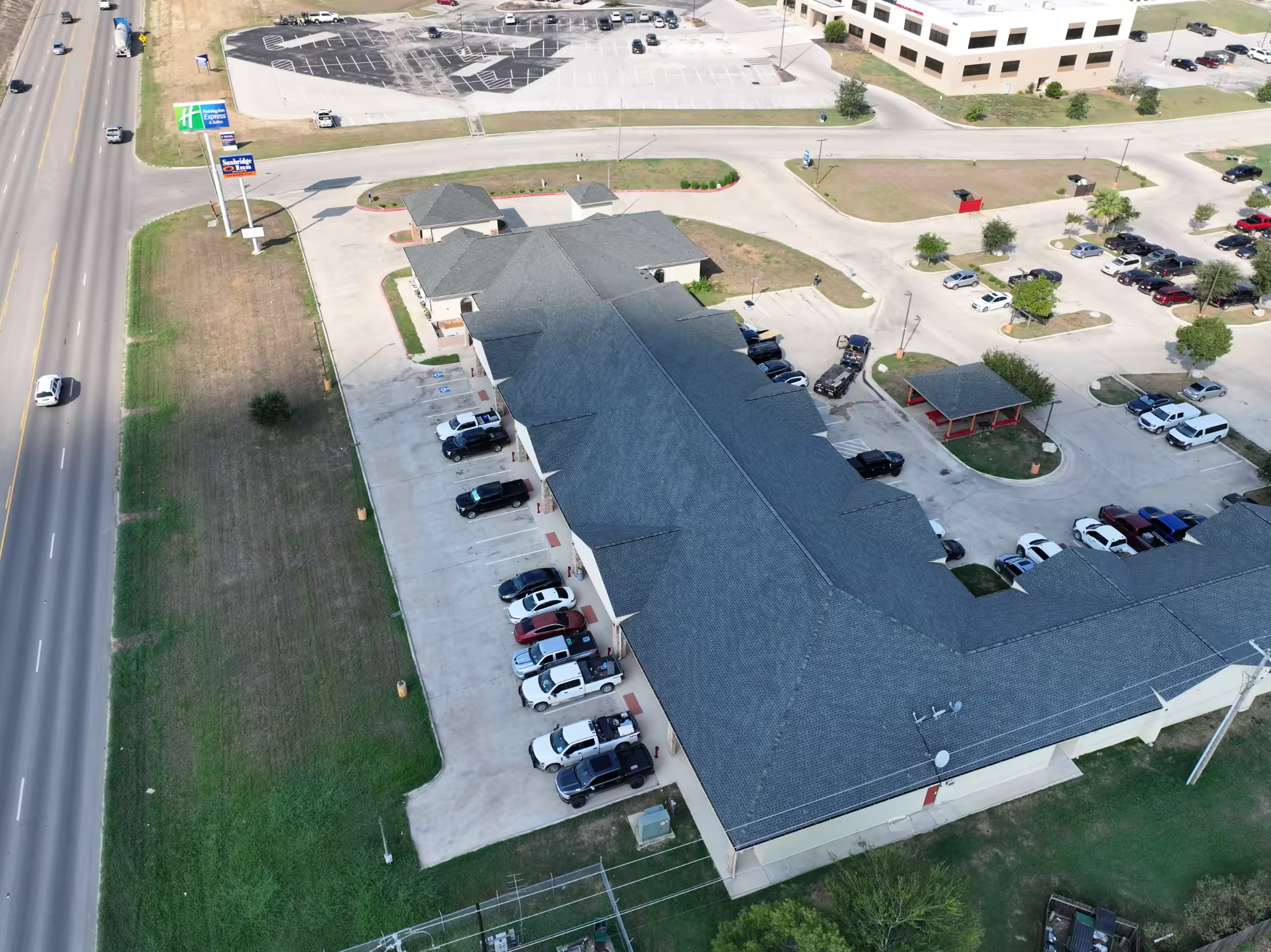 High-angle view showing the completed roof slopes and ridgelines at Sunbridge Inn & Suites