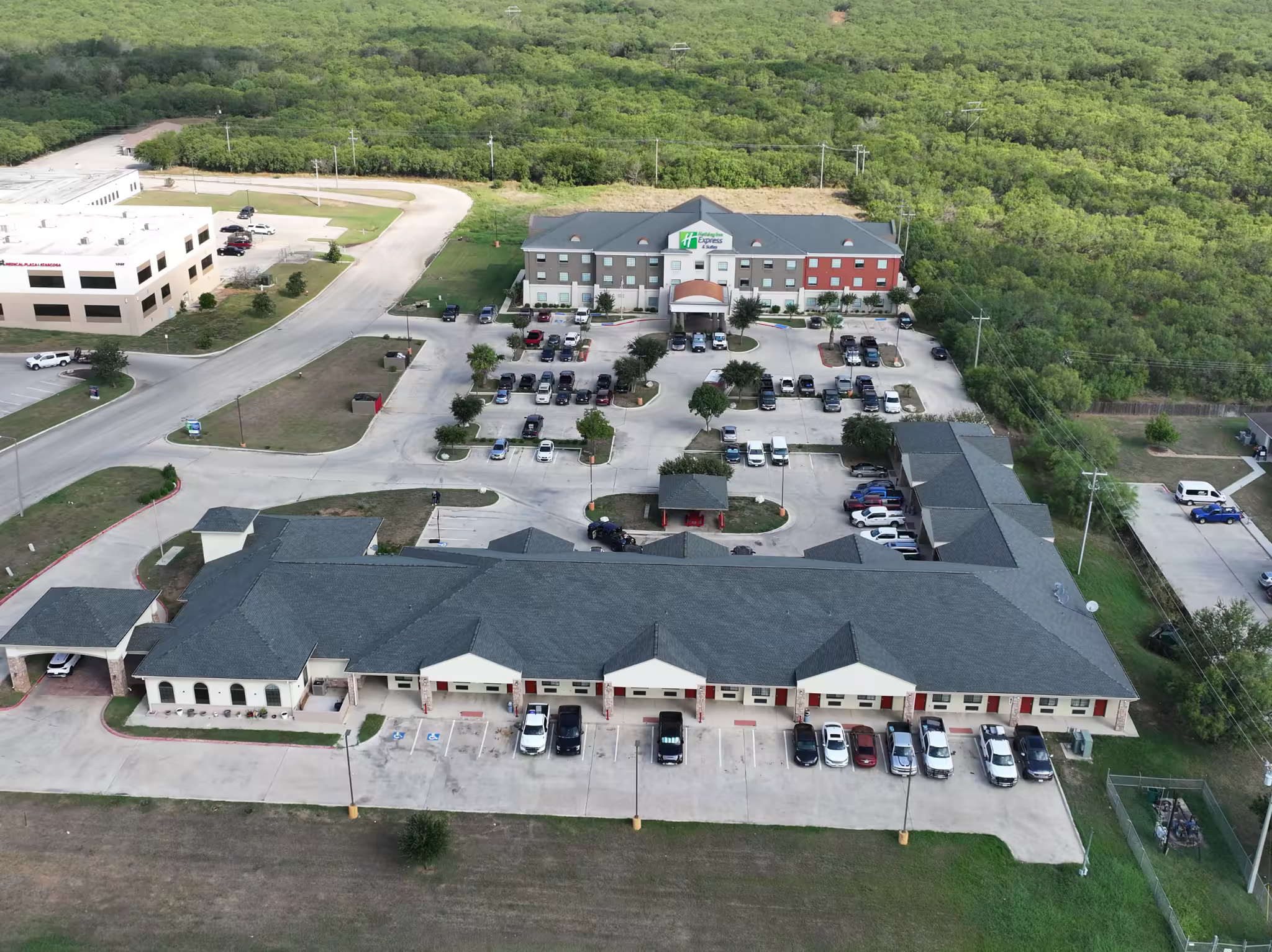 Aerial view of the completed commercial shingle roof at Sunbridge Inn & Suites
