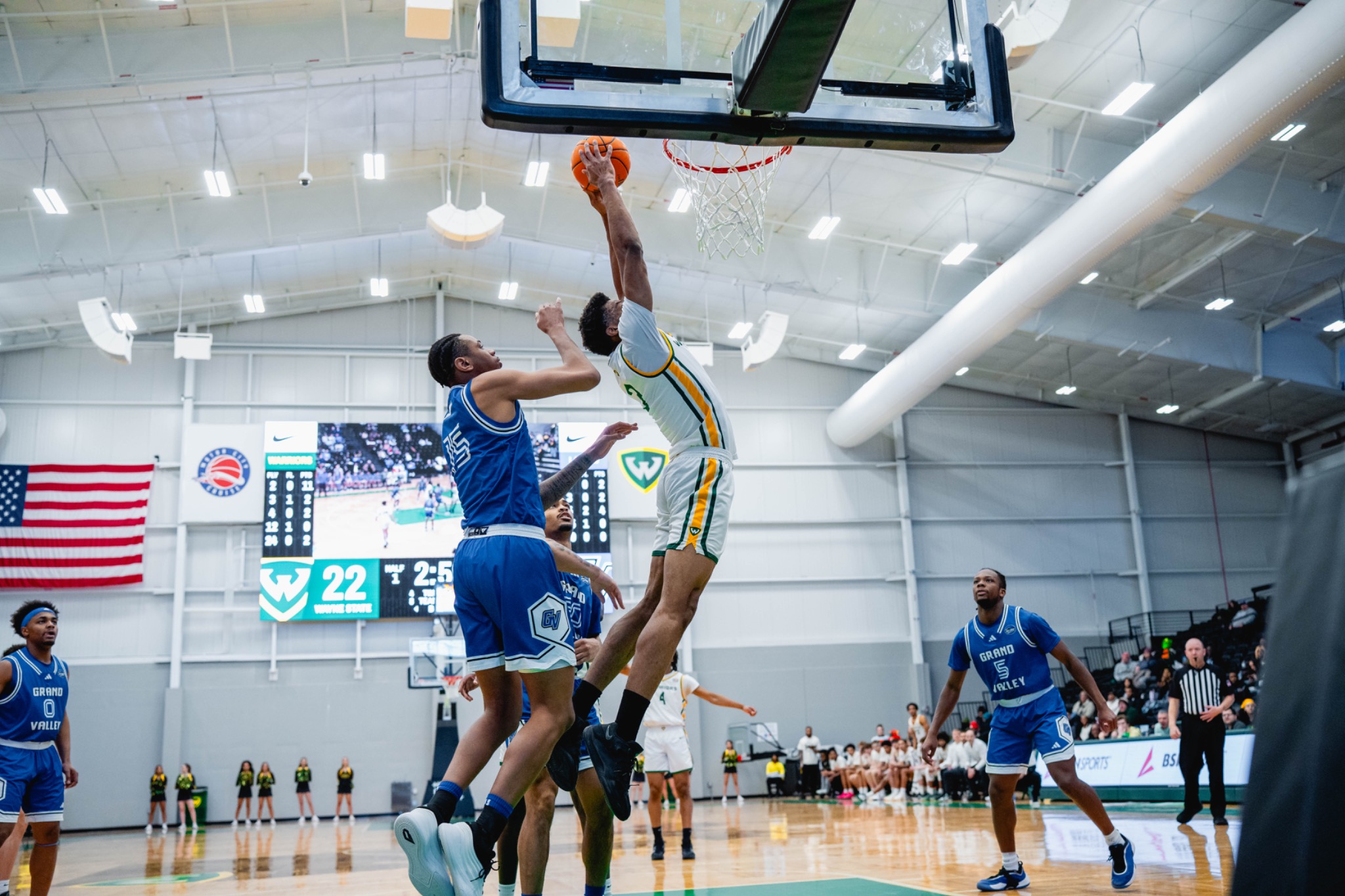 A Wayne State men’s basketball player attacks the rim against Grand Valley State.