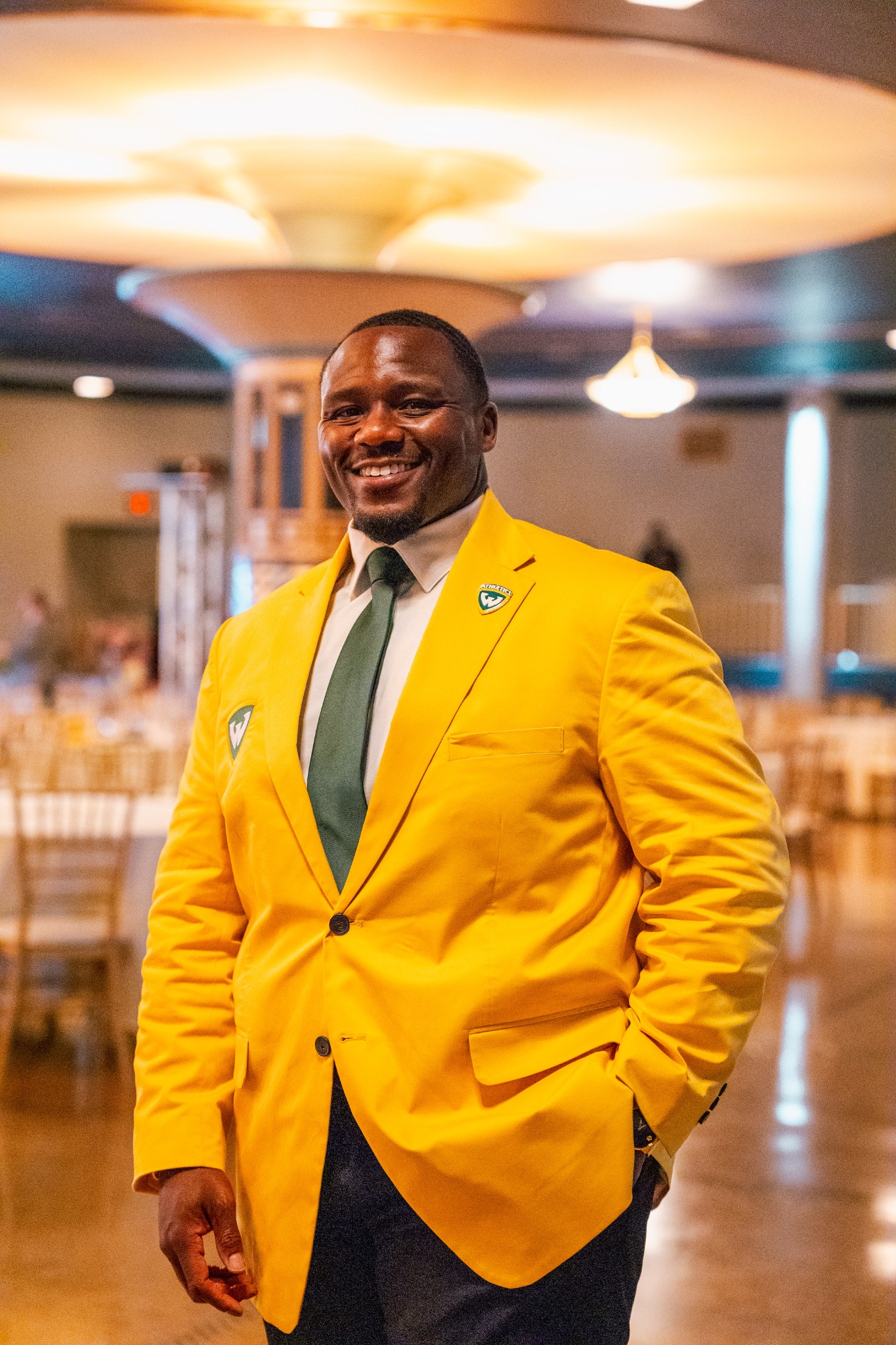 Ken Vaughn, Wayne State Associate Athletic Director for Major Gifts, wearing a gold Wayne State blazer.