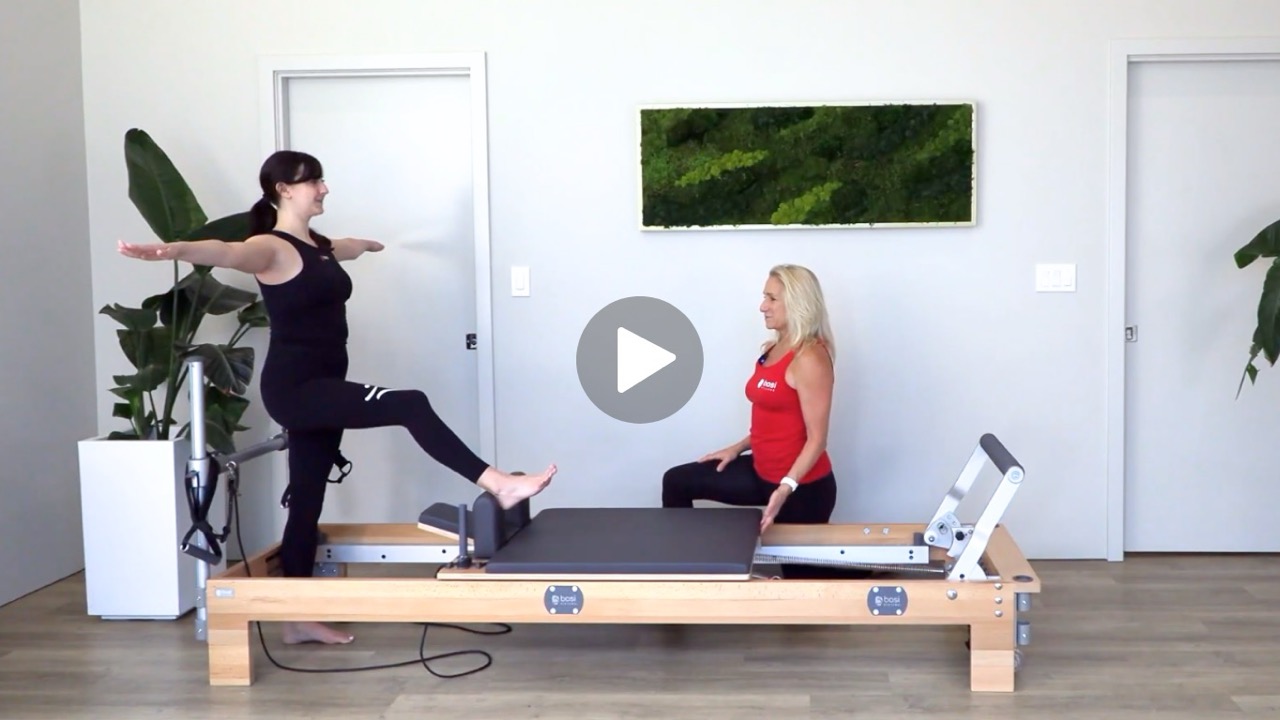 image of Pilates instructor helping an injured client.