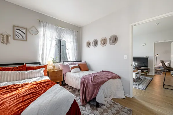 Bedroom with beds and large window