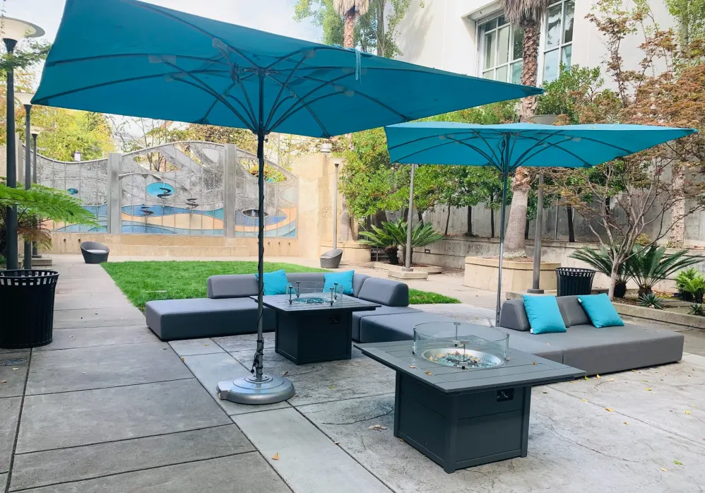Fire pit area with chairs and umbrellas