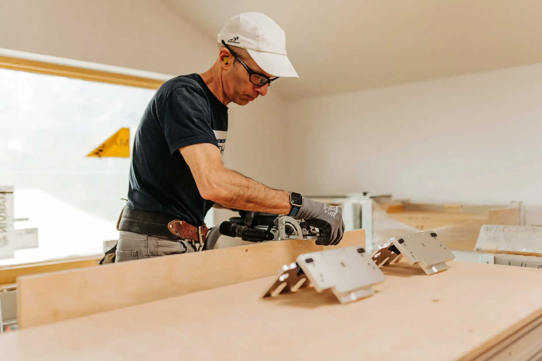 a man setting brackets on a workshop