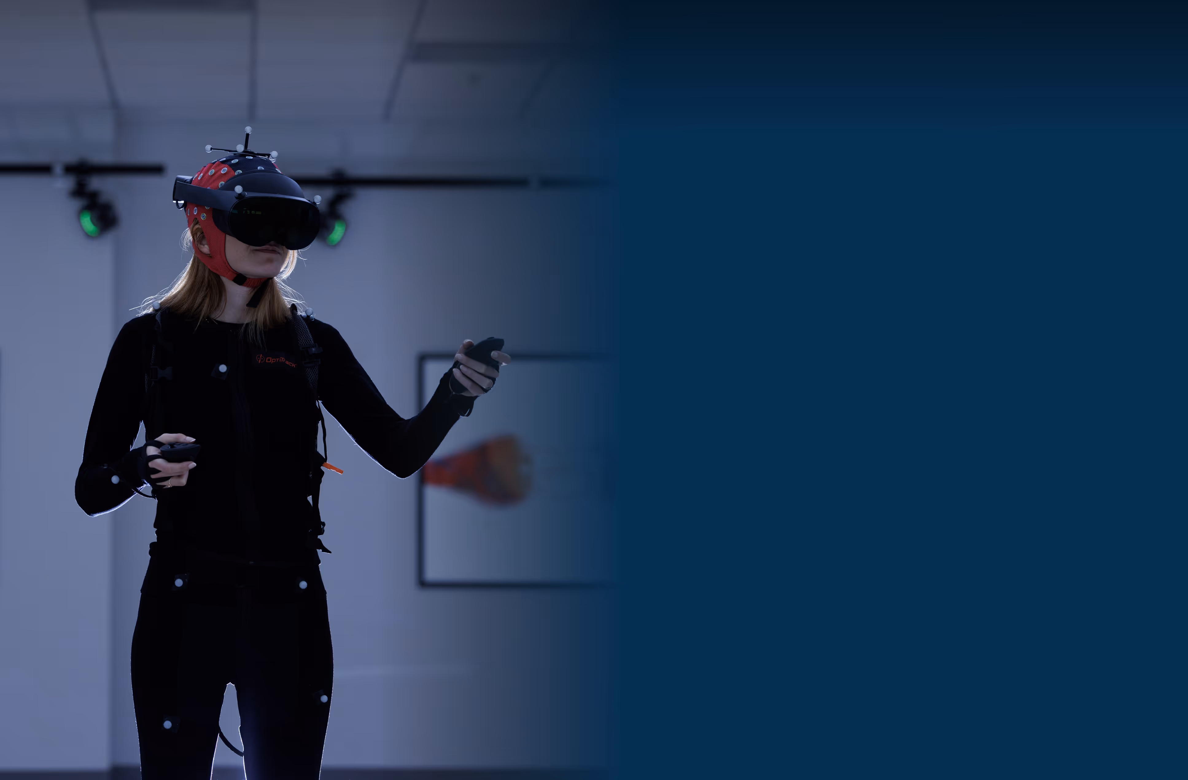 A participant wearing a mobile scalp EEG system and virutal reality headset, participating in research tasks.