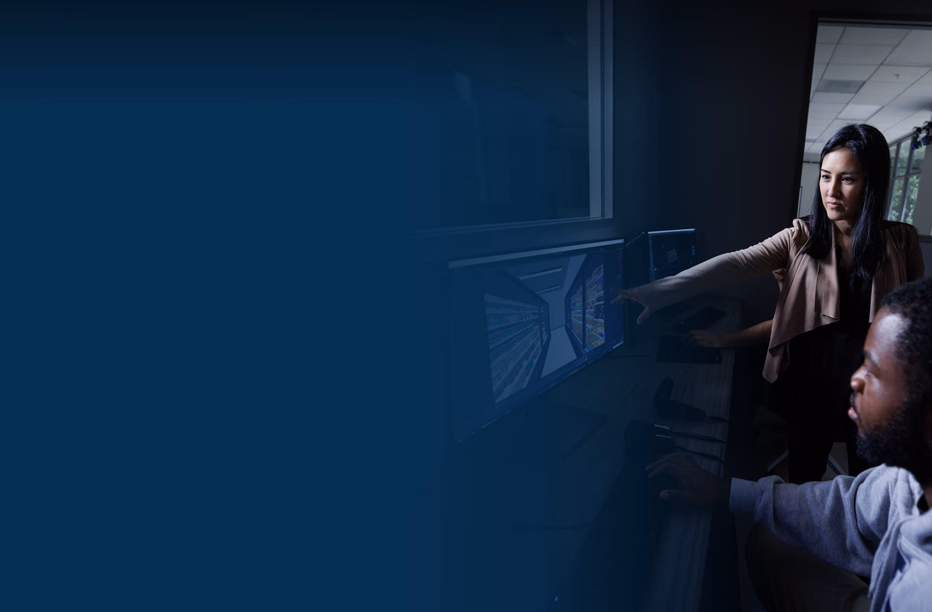 Dr. Suthana and a team member examining a computer screen.