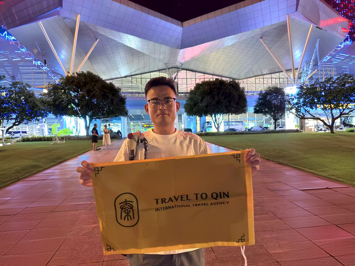 TravelToQin guide at airport pickup