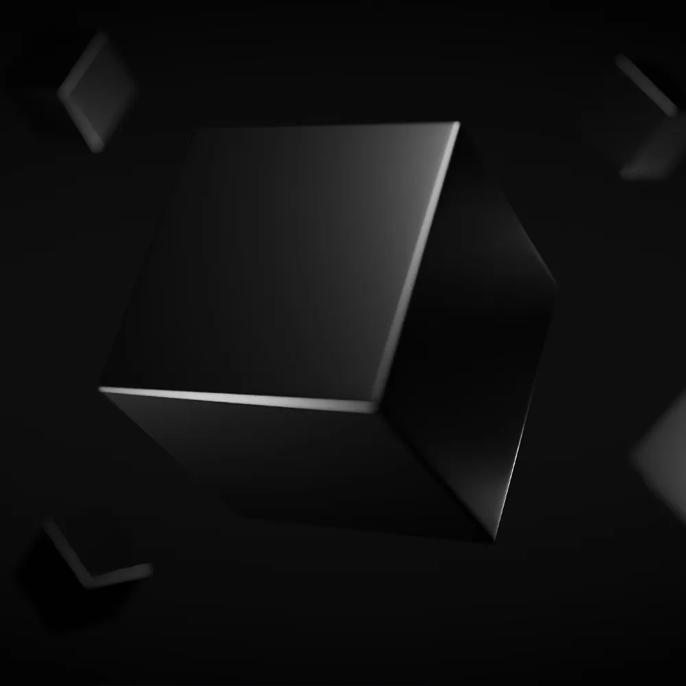 black cube floating in dark space with blurred smaller cubes in the background.