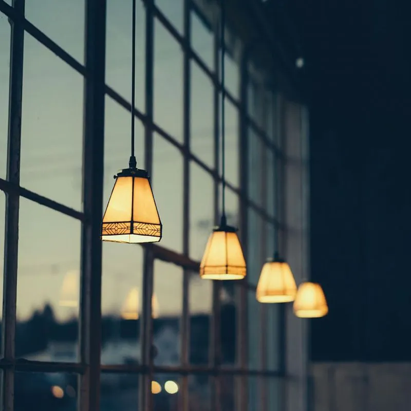 Row of lights switched on hanging from ceiling 