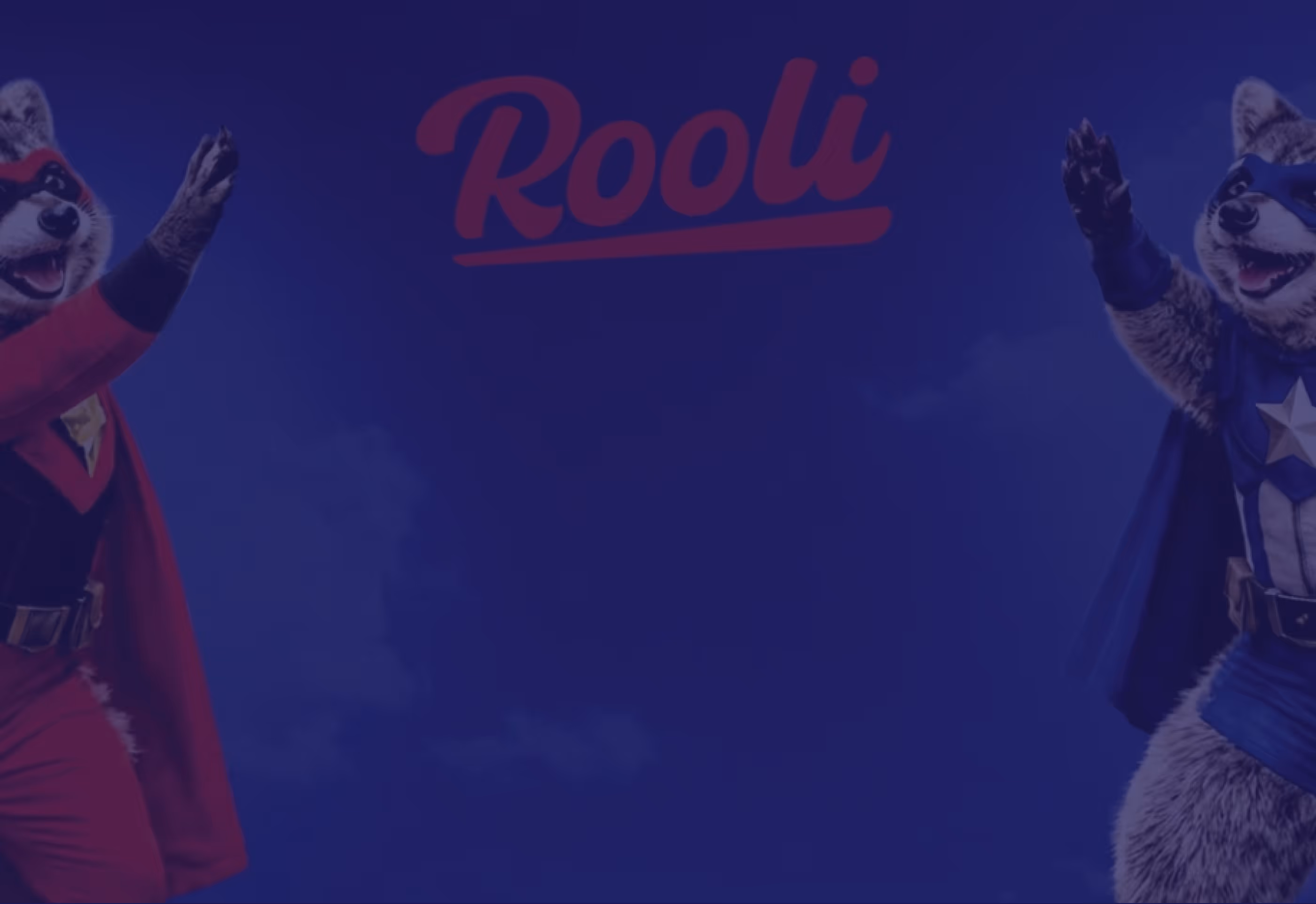 Two raccoon mascots dressed as superheroes in red and blue costumes with capes, positioned on the left and right sides, with the word 'Rooli' in red cursive centered above them.