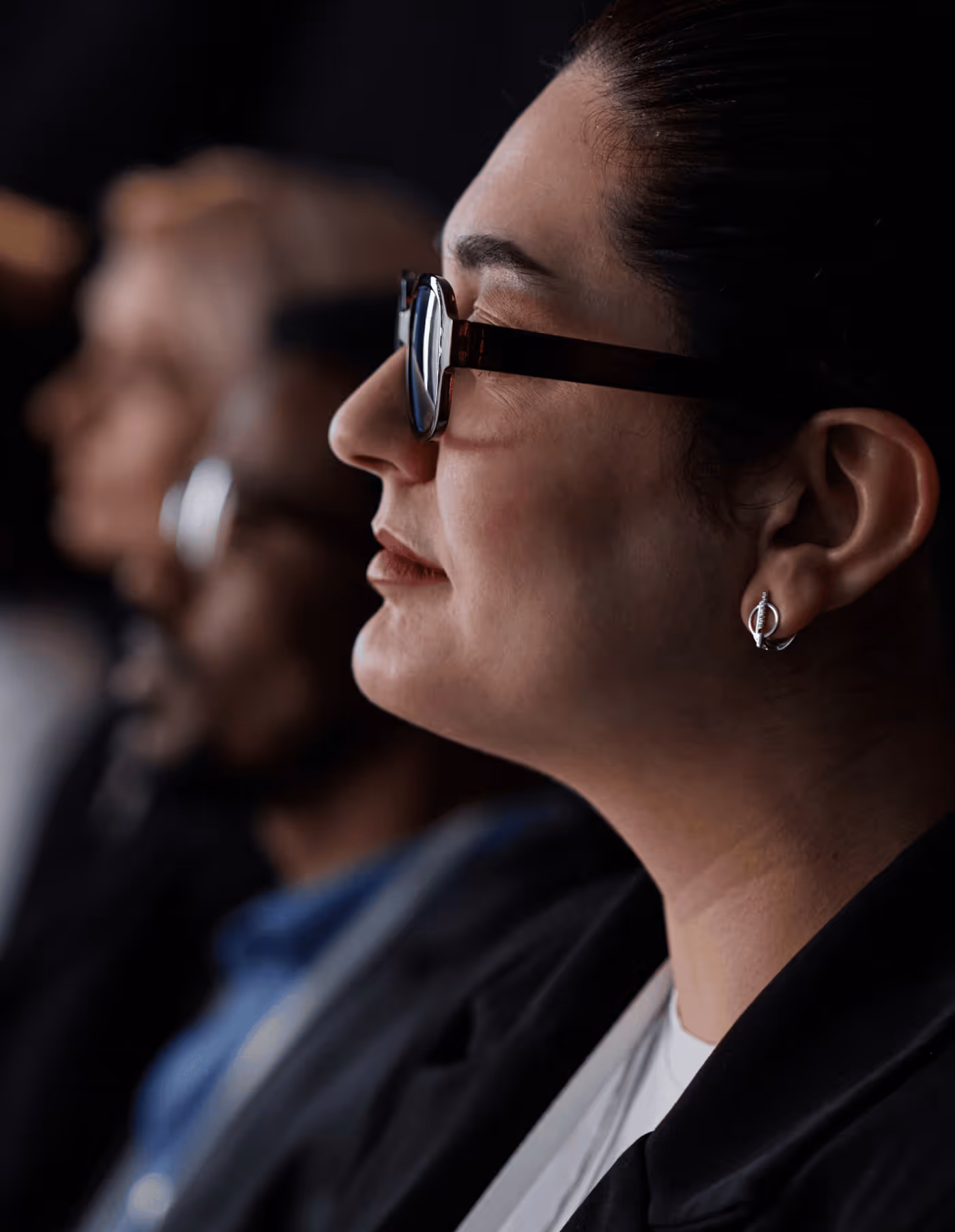 A Woman Sitting in an Audience - Photo