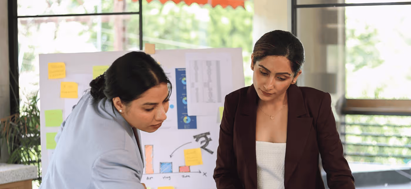 Two Women Discussing in a Meeting