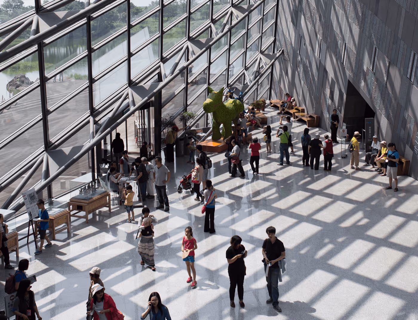 A Large Hall With People Walking - Photo