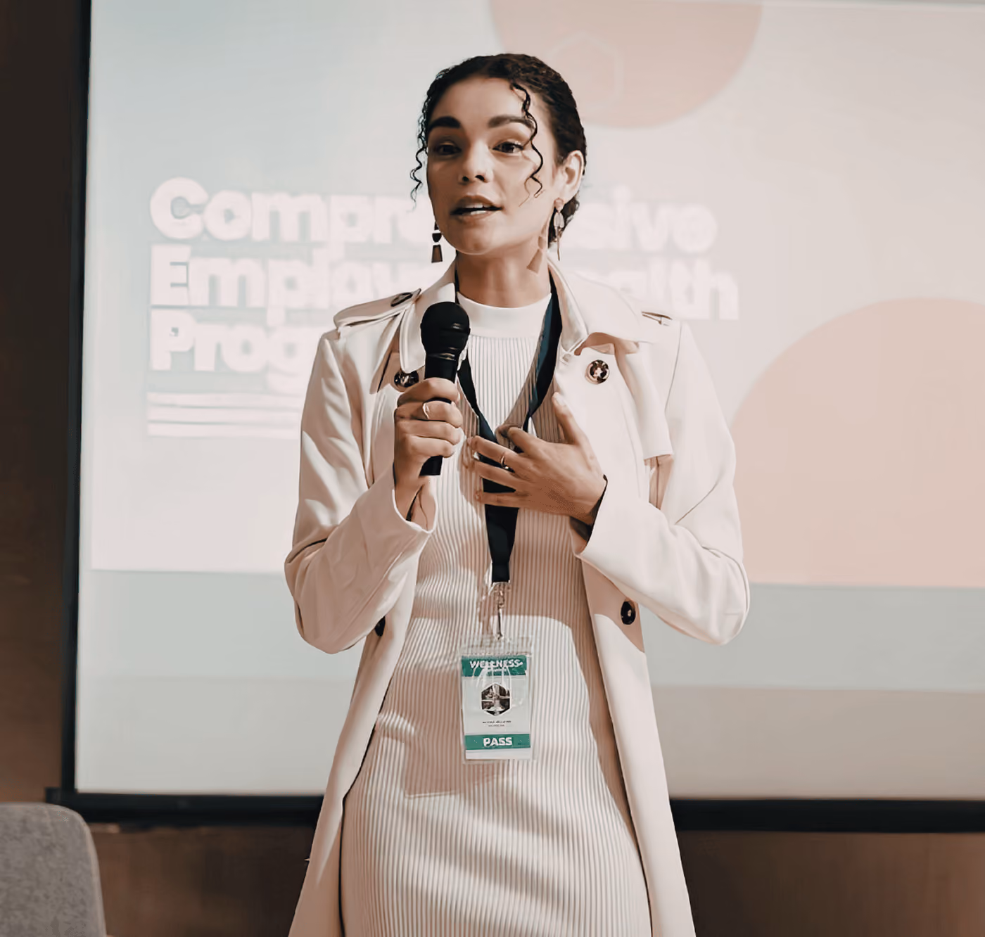 A Woman Speaking on a Stage - Photo