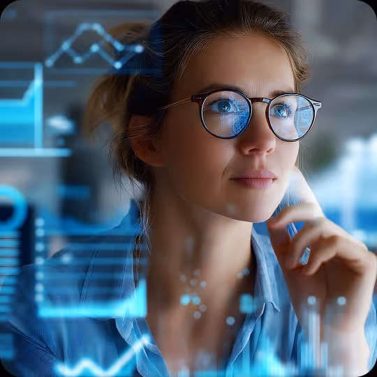Woman with glasses touching her chin looking thoughtfully at transparent digital graphs and charts.