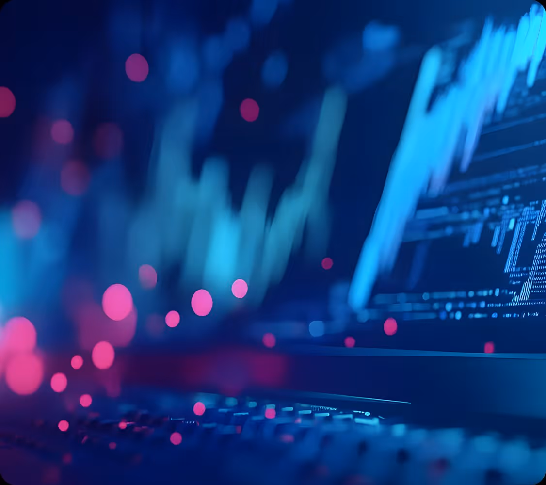 Blurred digital screens showing data charts with glowing pink dots in blue and purple tones.
