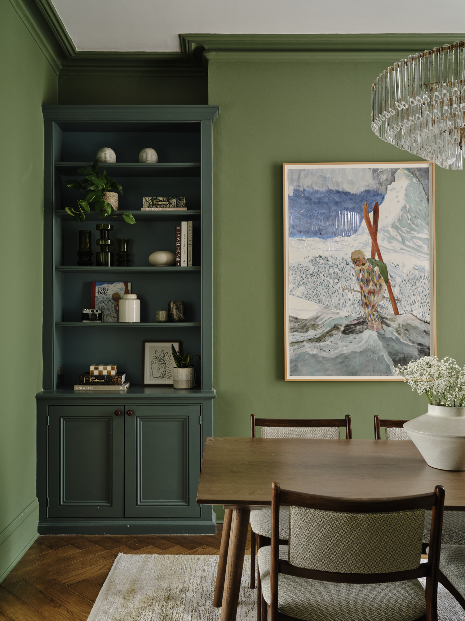 Interior with green cabinetry and dining table