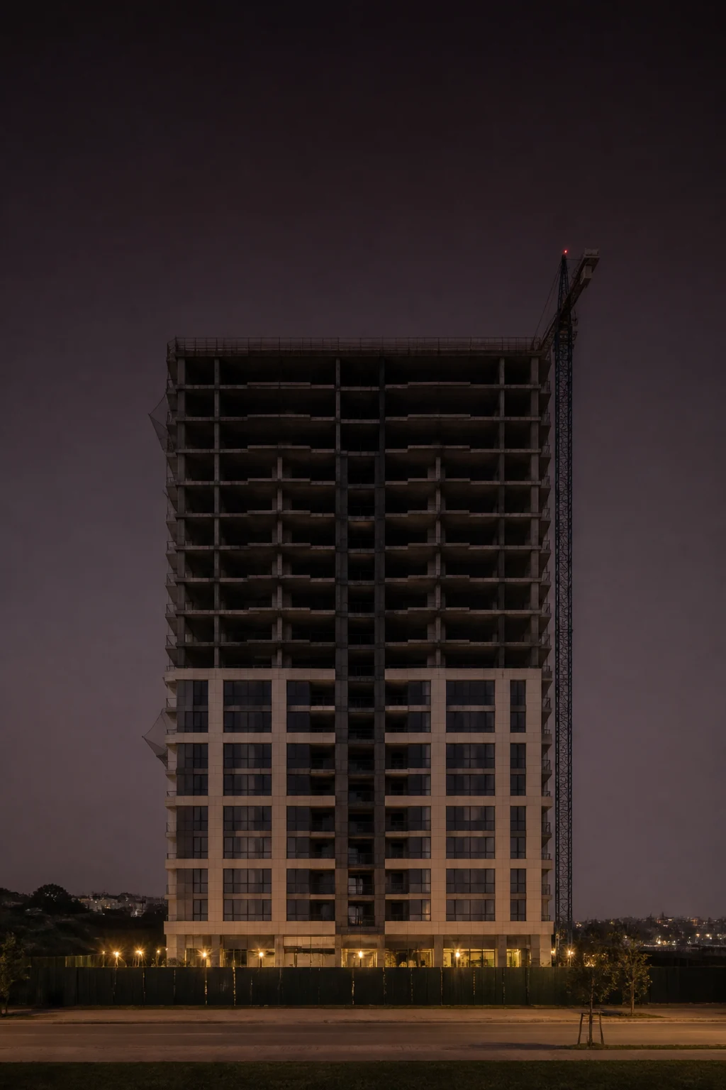 A residential tower under construction at dusk