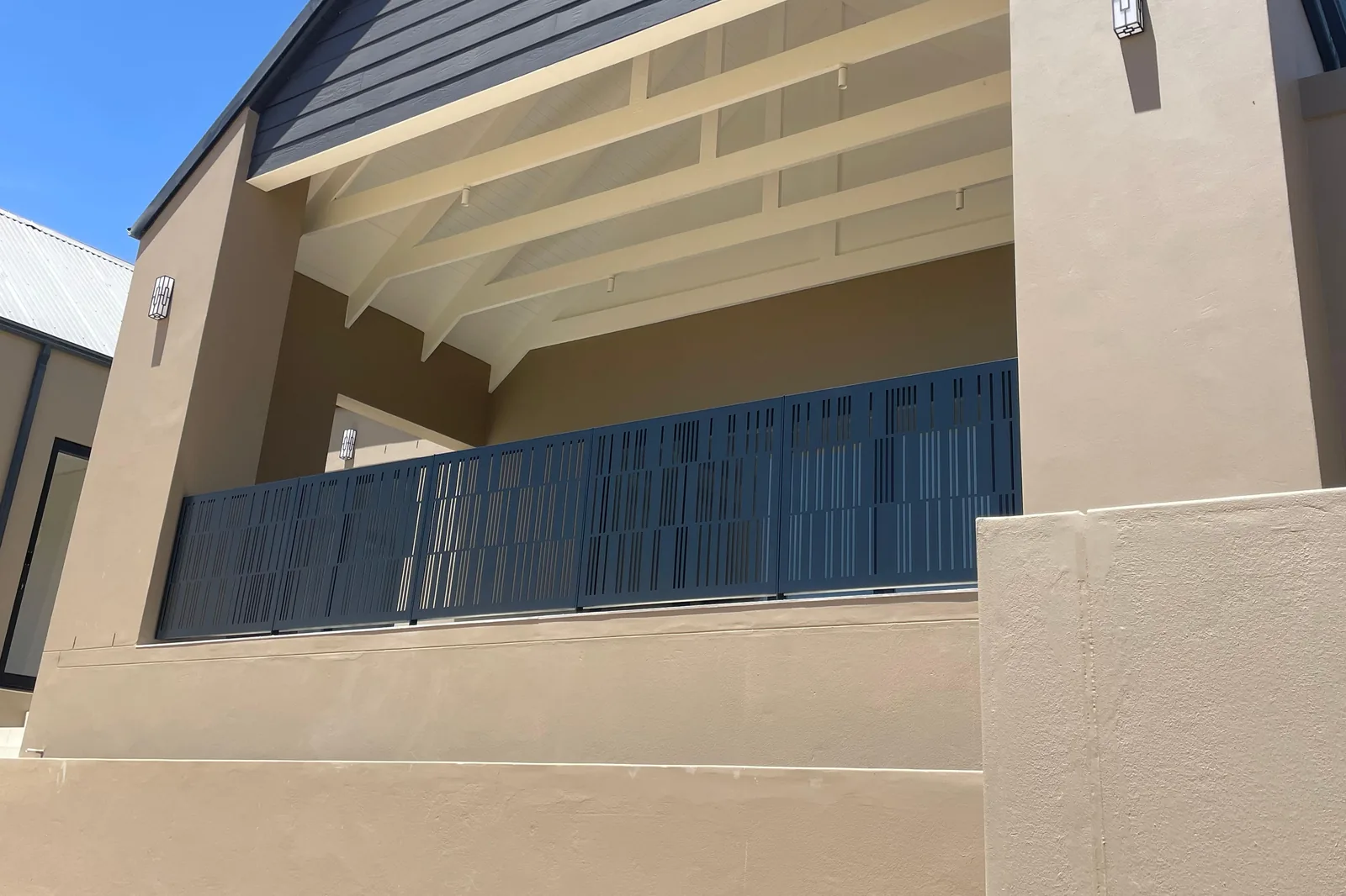 Slot-pattern perforated aluminium balustrade panels on a house balcony, Malmesbury