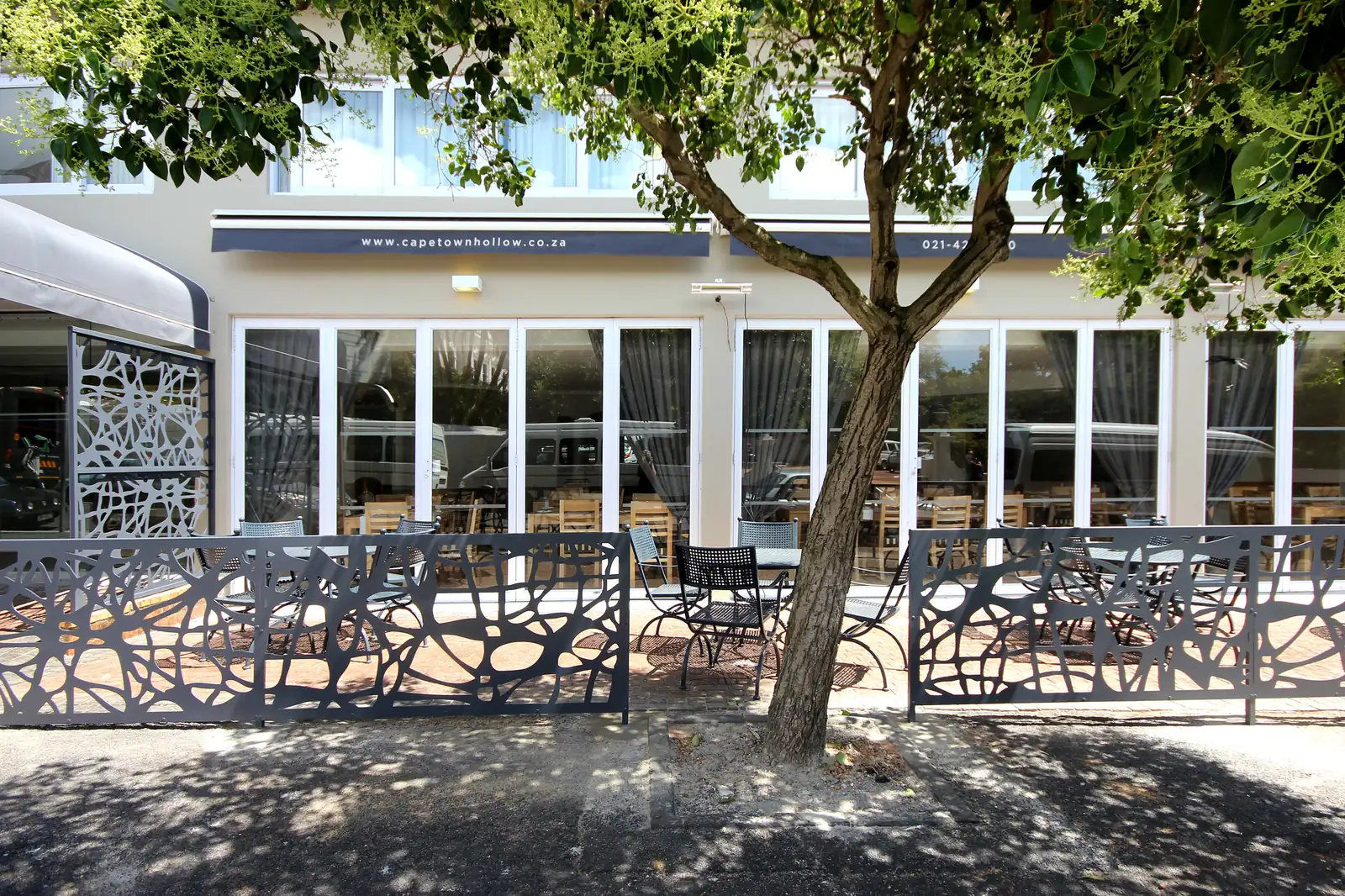Organic-pattern perforated aluminium balustrade panels around the terrace at Cape Town Hollow