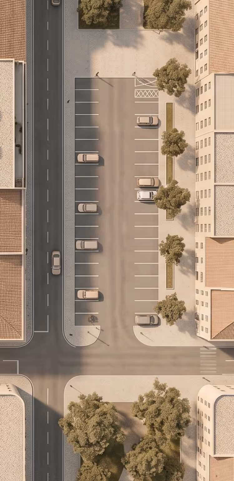 Aerial view of a parking lot with cars, trees, and surrounding buildings on city streets.