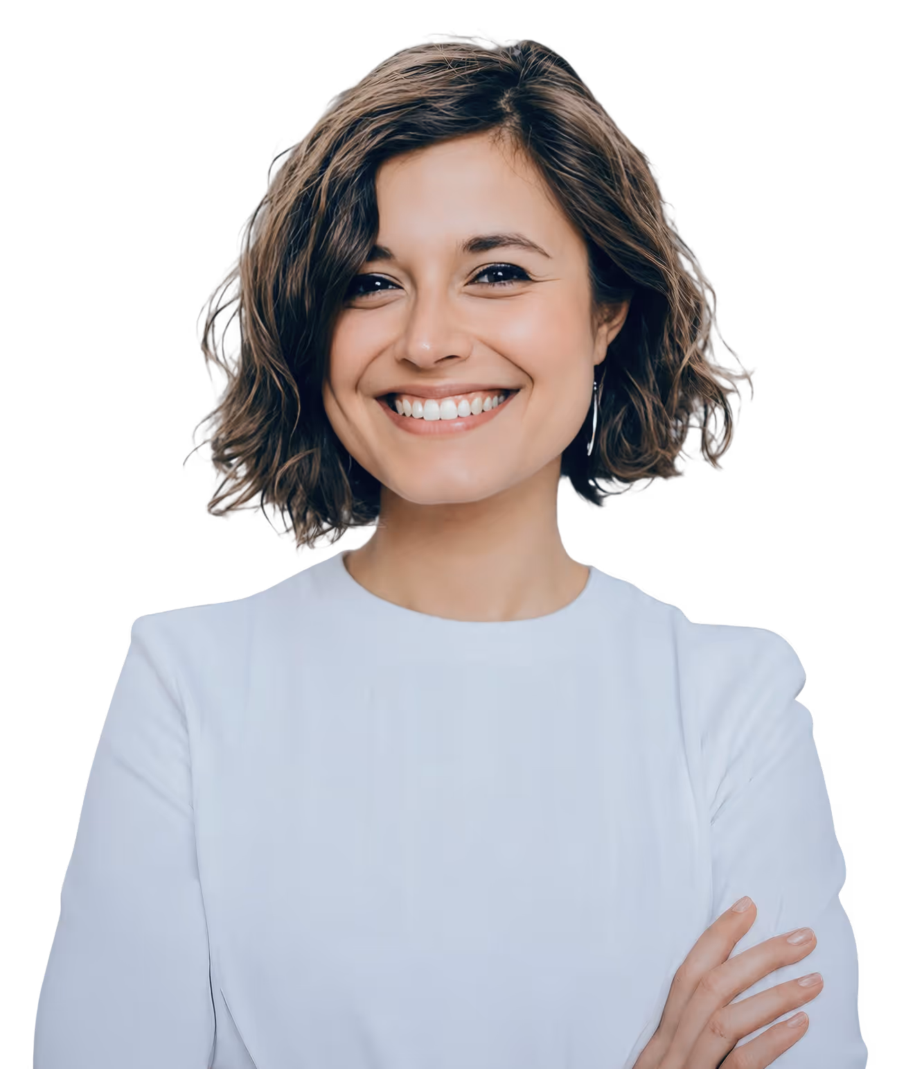 Smiling woman with short curly hair wearing a white shirt and crossed arms on black background.
