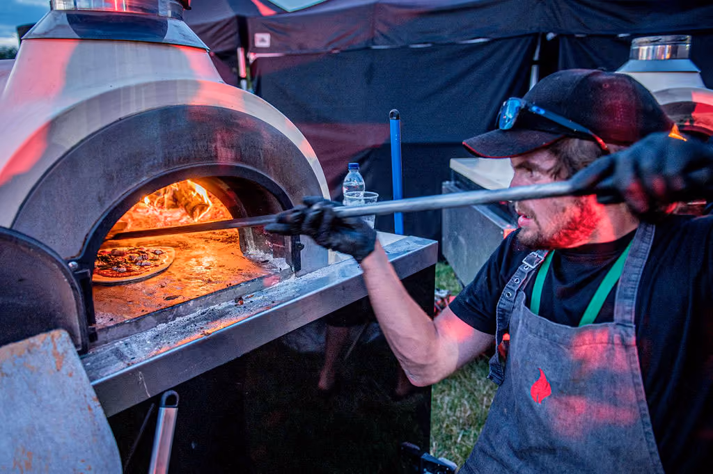 pizza inside a wood-fired oven.