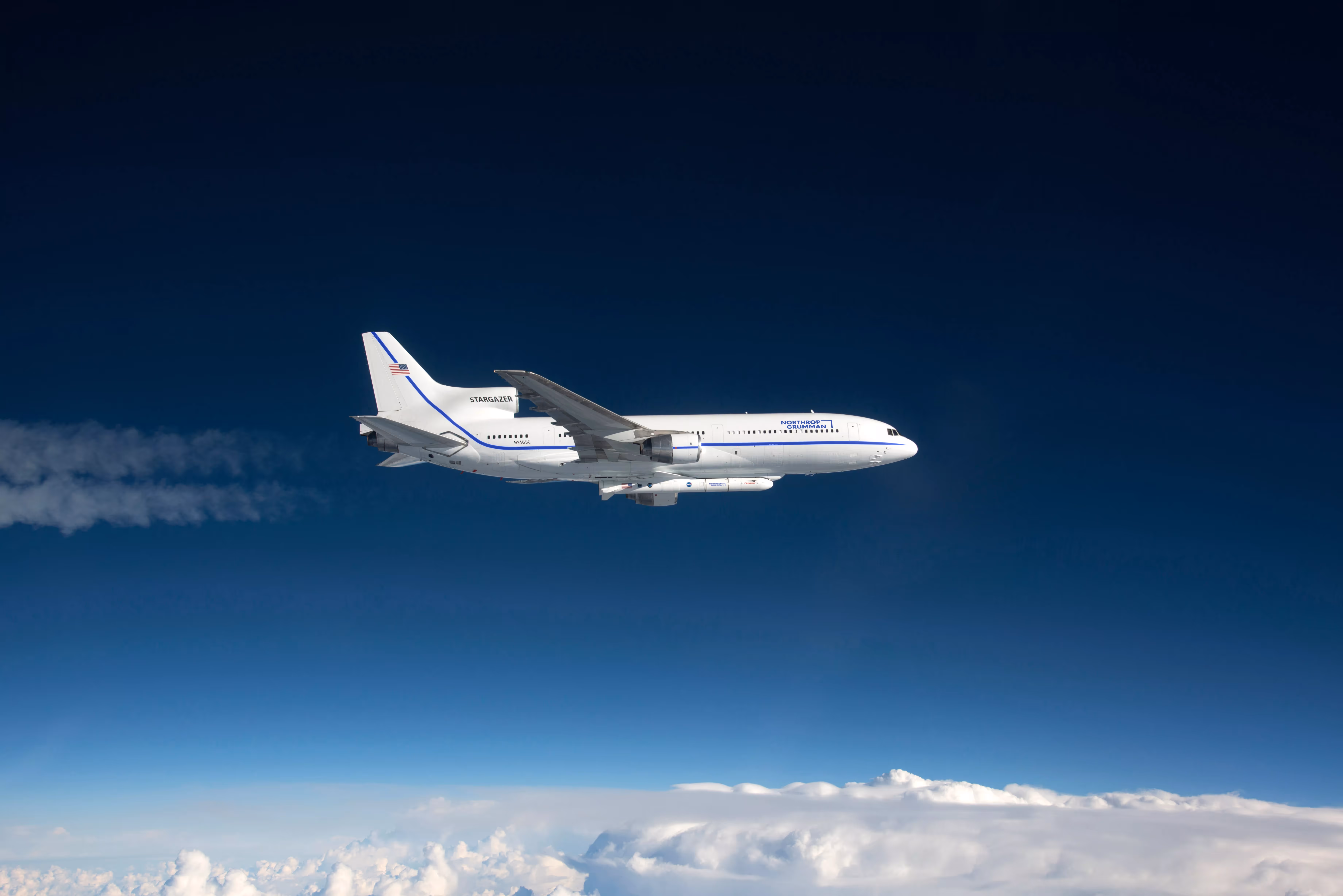 A plane flying high above ground.