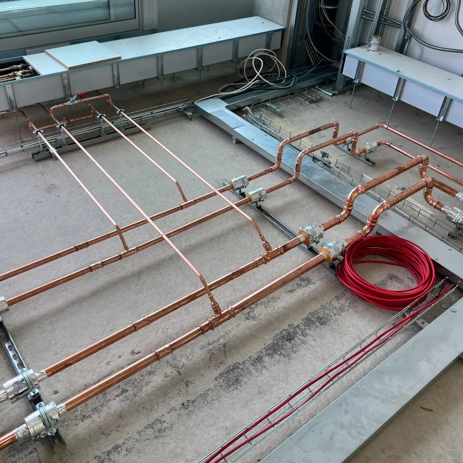 First fix commercial mechanical services pipework installed within a new-build construction project.