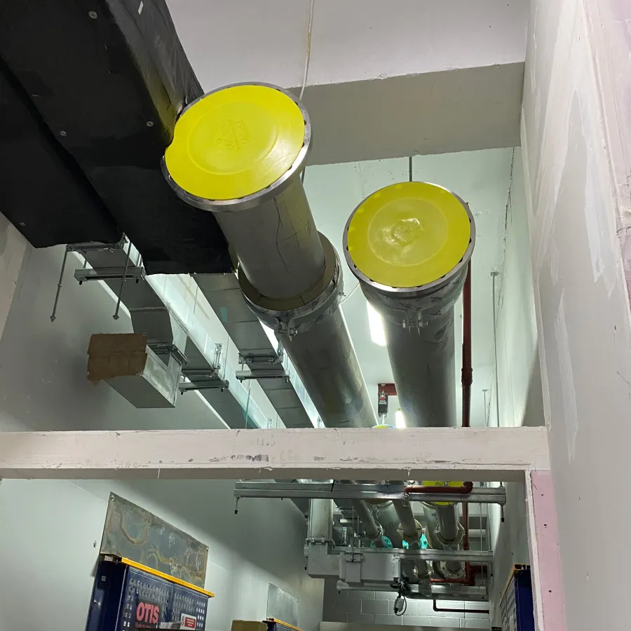 Installation of large-diameter insulated pipework for a commercial heating and mechanical services system.