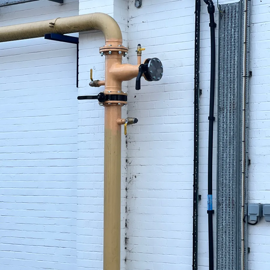 New commercial gas pipework installation with isolation valve and support brackets.