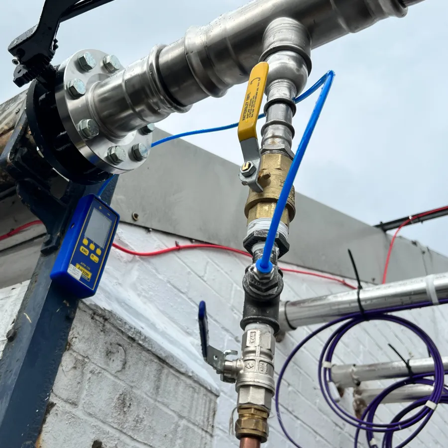 Commercial gas pipework pressure testing using digital equipment to verify system integrity.