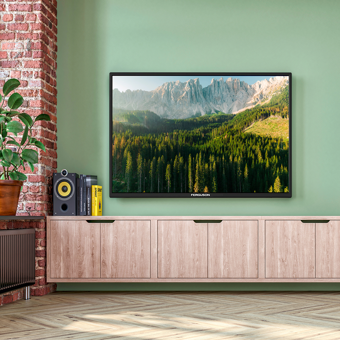 Wall-mounted TV showing mountain and forest landscape above a wooden cabinet with books and speaker.