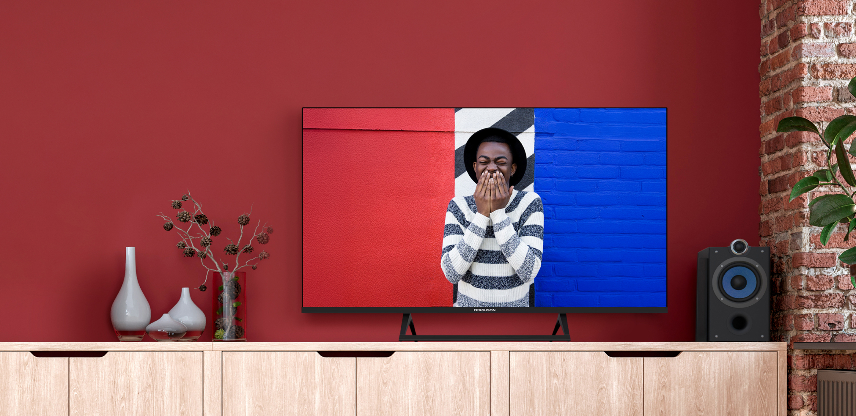 Ferguson smart TV on a red wall above a wooden sideboard