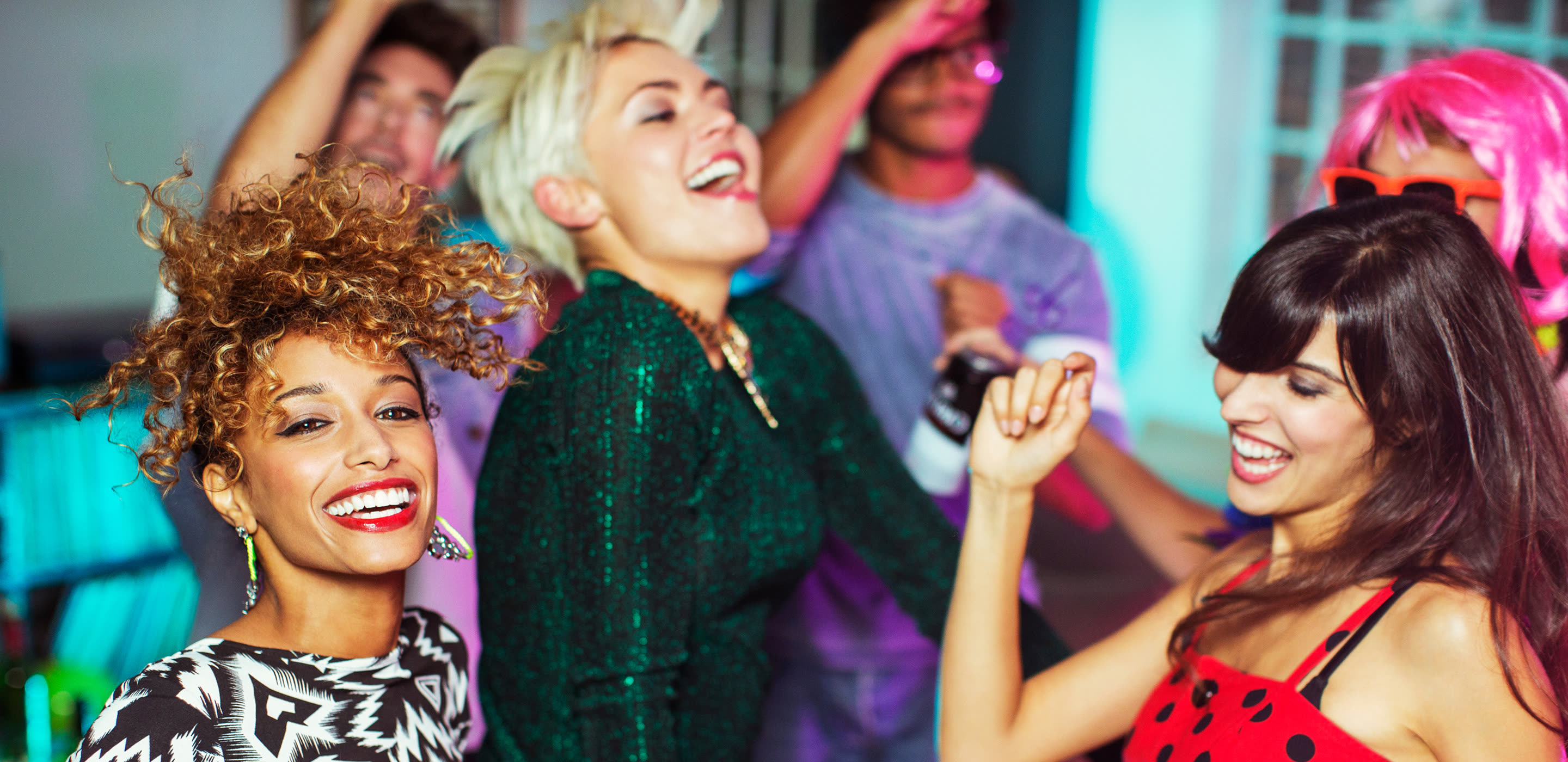 Friends dancing and laughing together at a party