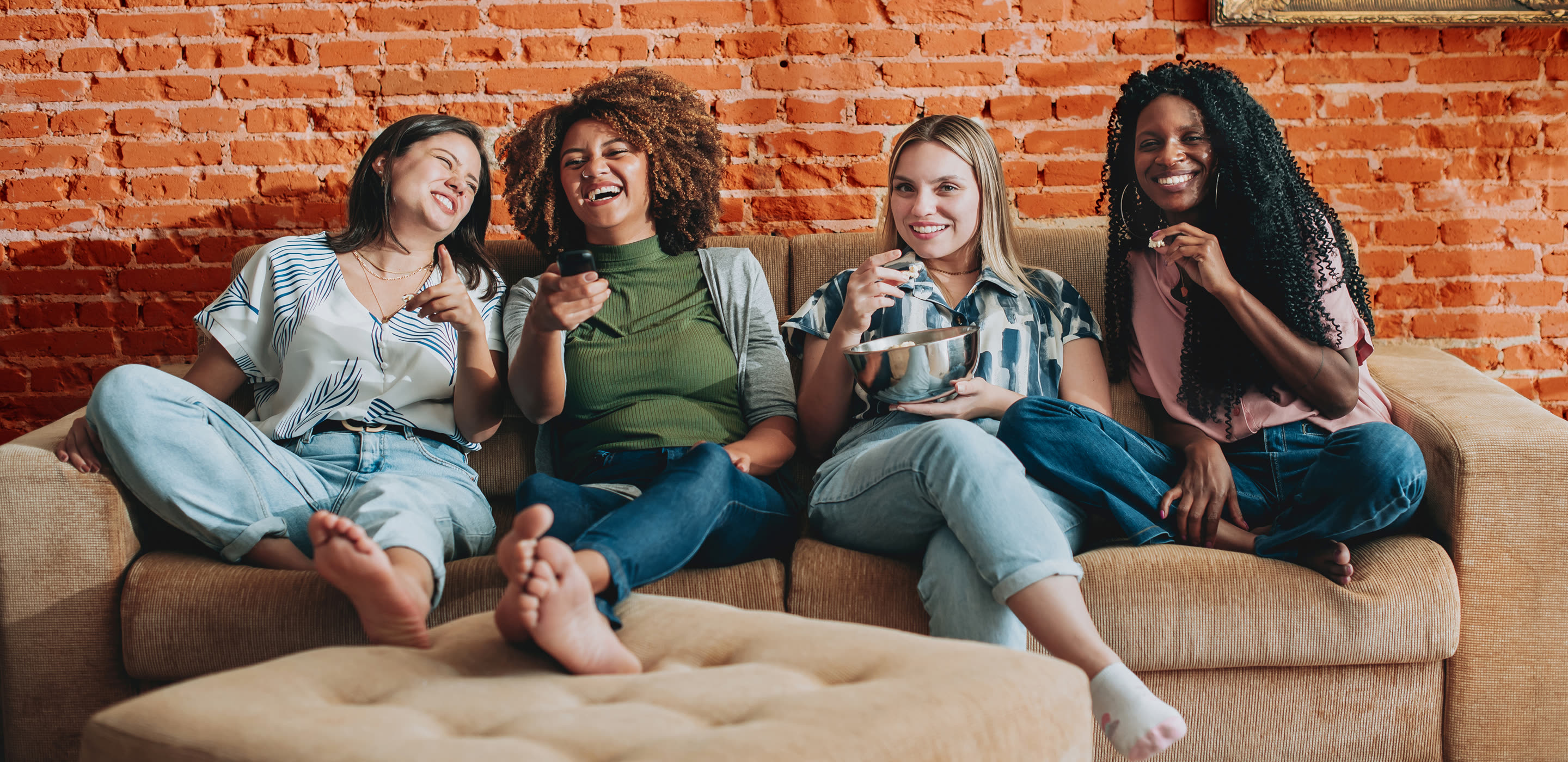 Friends watching a movie together on a sofa