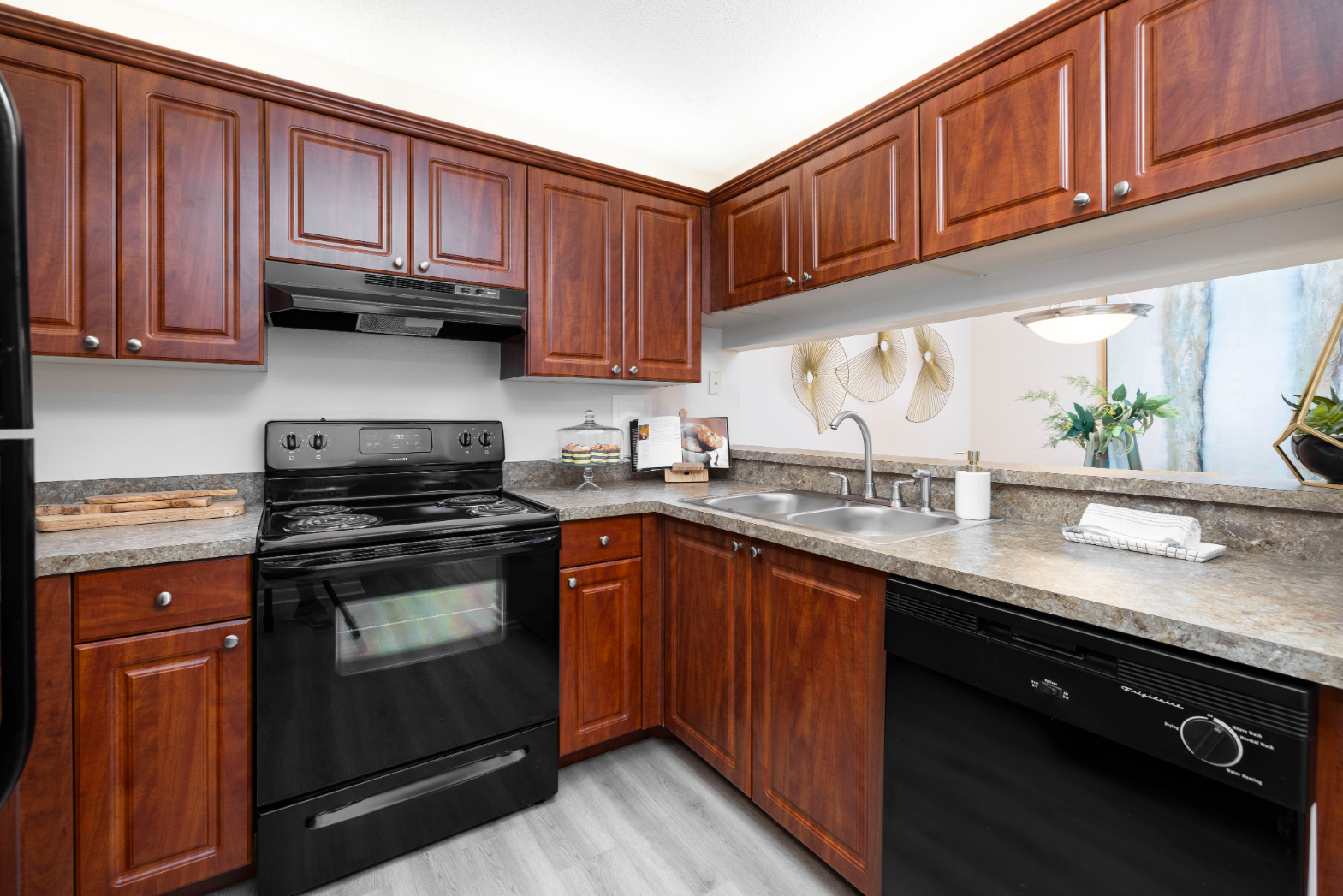 Kitchen with brown cabinets and black appliances