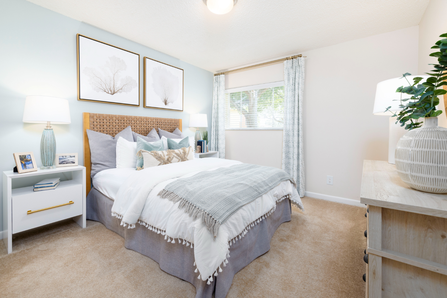 Bedroom with bed, dresser, and large window