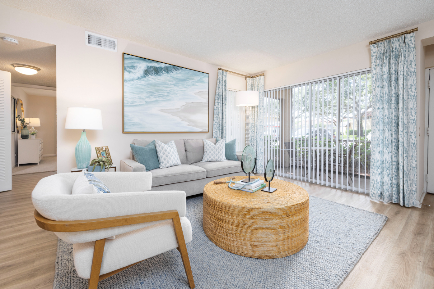 Living area with sofa and coffee table with view of balcony doors