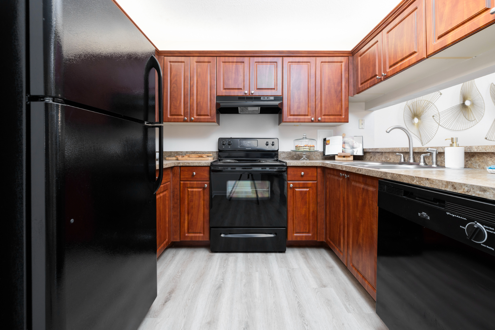 Kitchen with brown cabinets and black appliances