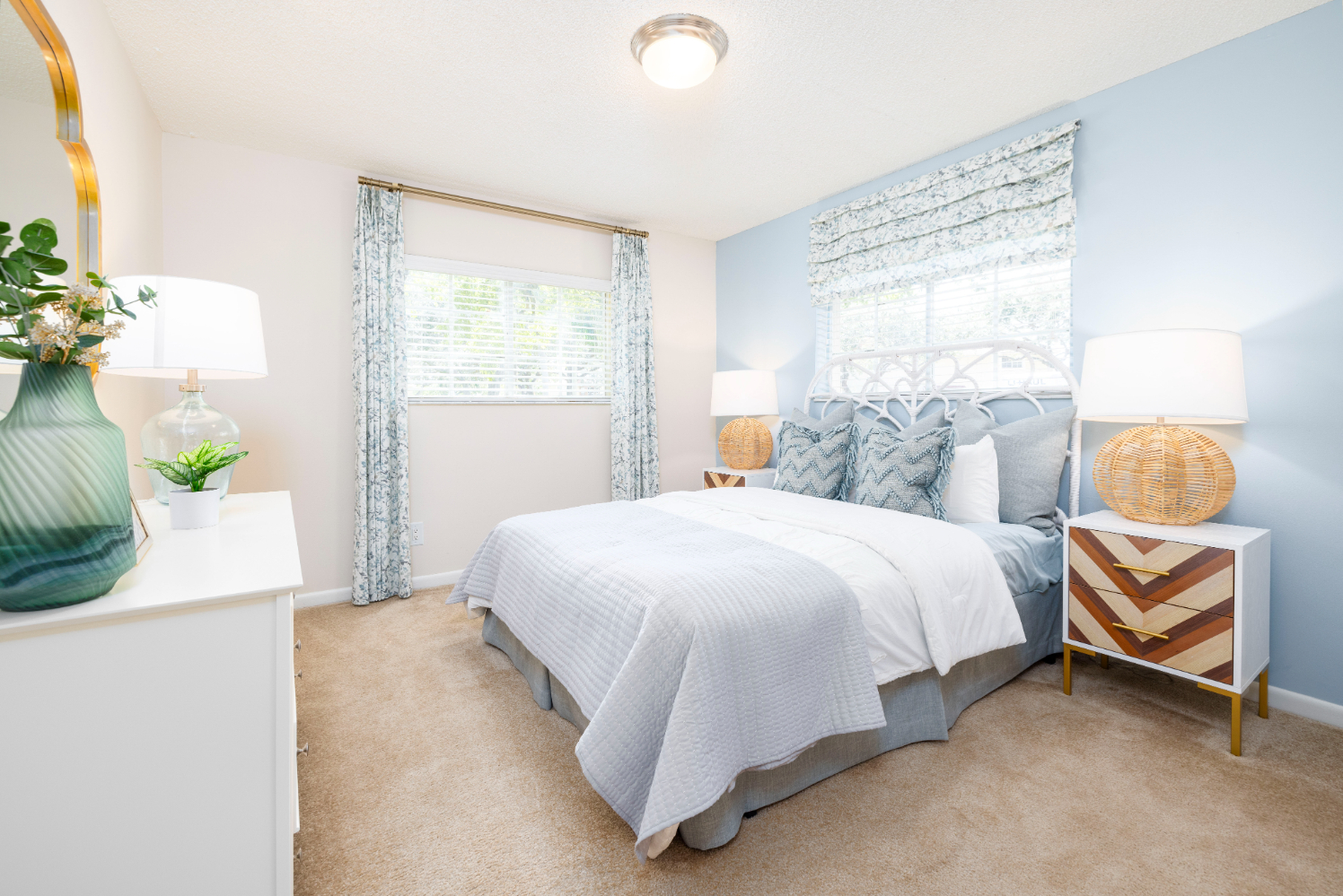 Bedroom with bed, dresser, and large window