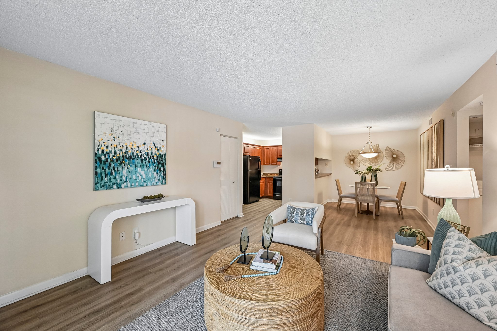 Living area with sofa and coffee table with view of dining area Azalea Village