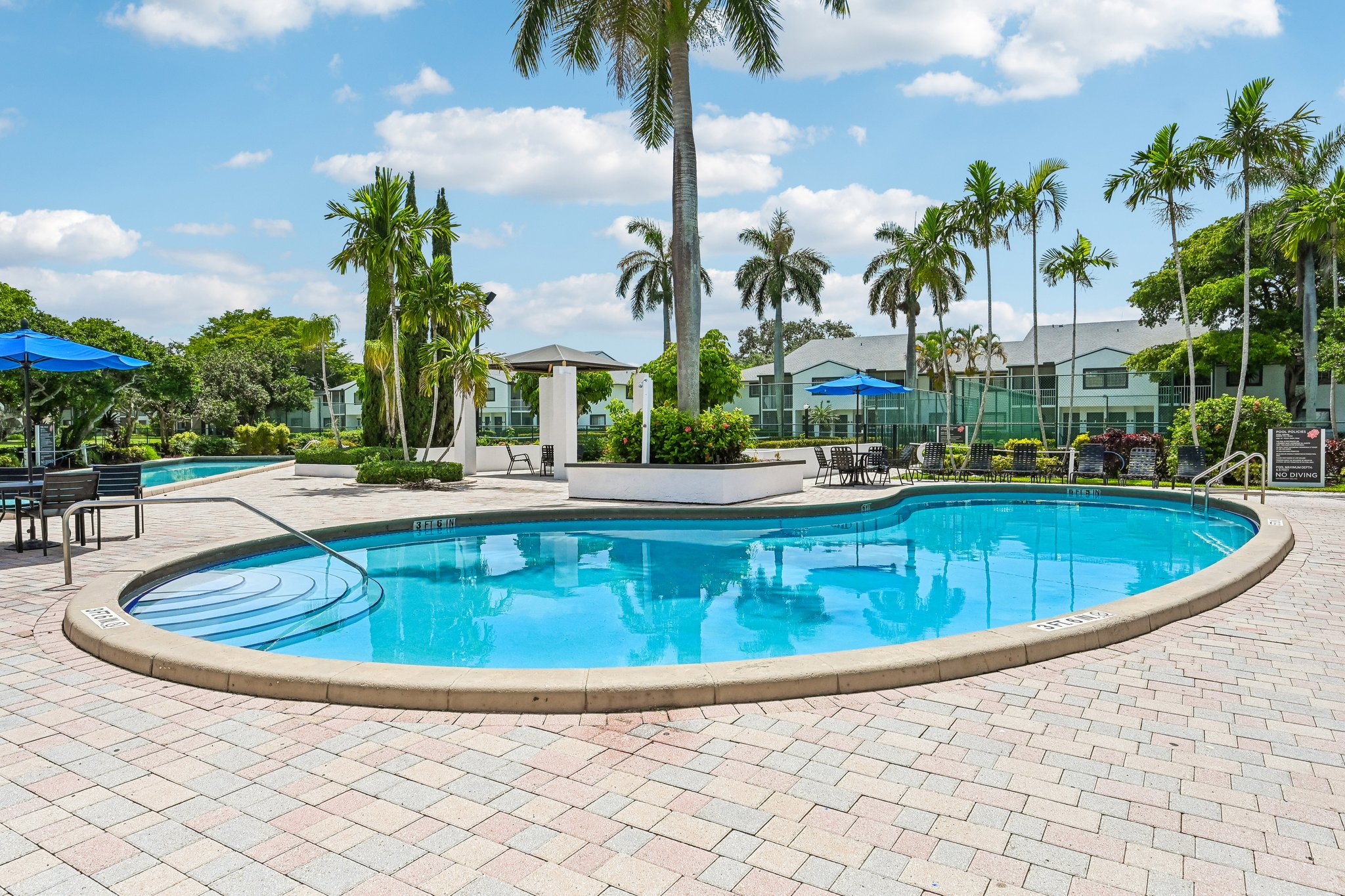 Round swimming pool with lounge chairs Azalea Village 