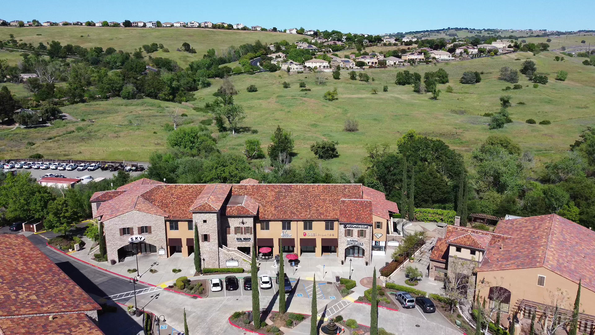 Aerial view of El Dorado Hills Town Center, home of the studio, with green hills behind