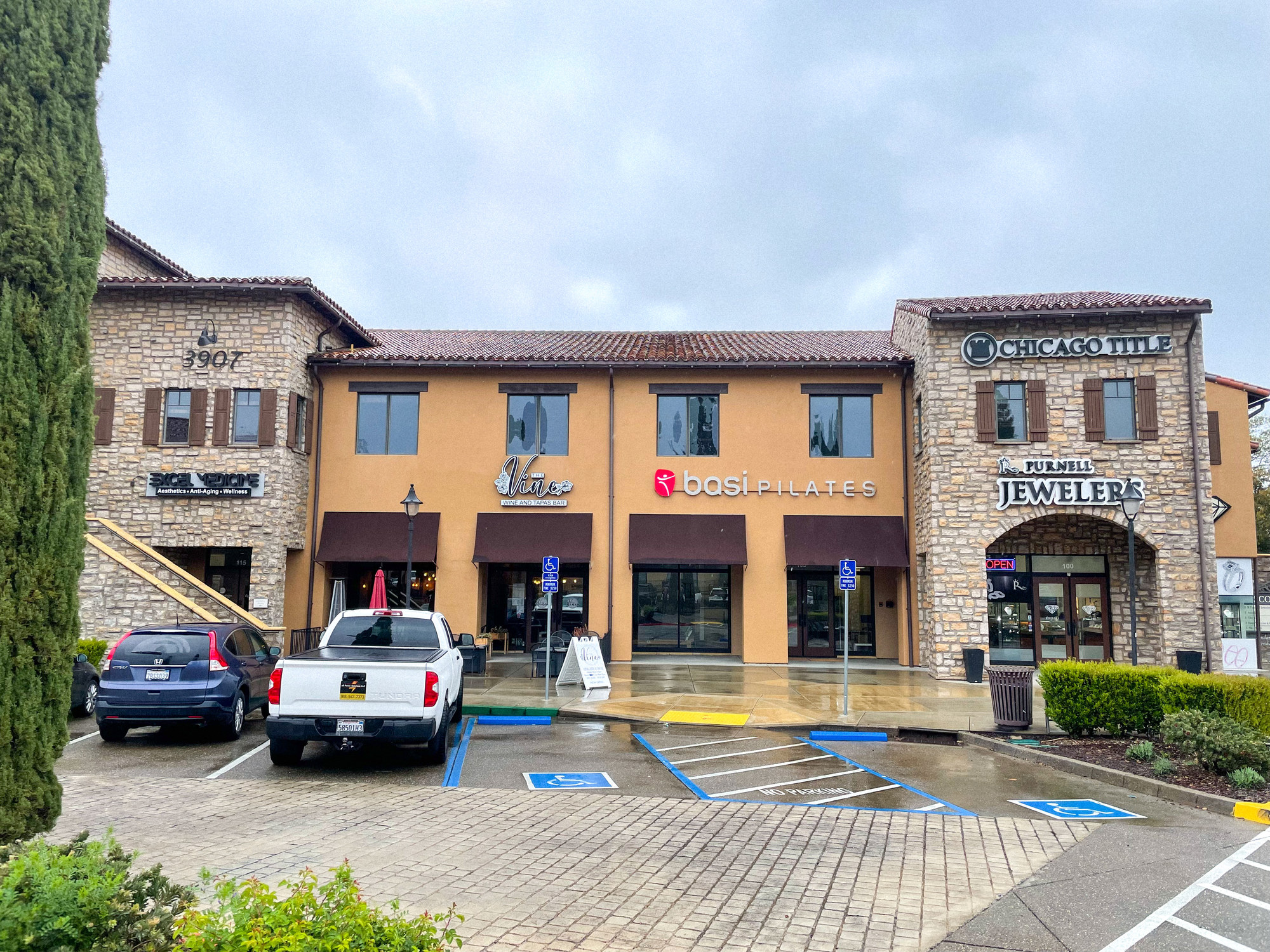 Exterior of the El Dorado Hills Town Center building with the BASI Pilates studio sign