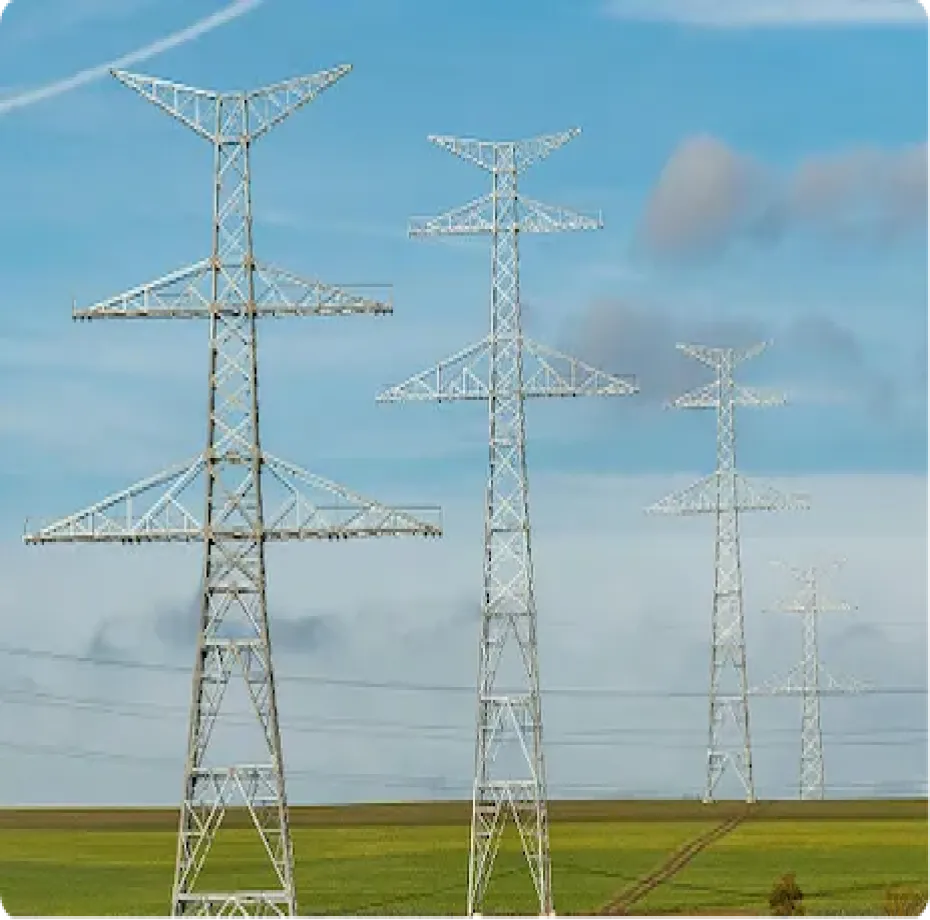 Transmission towers across a green field