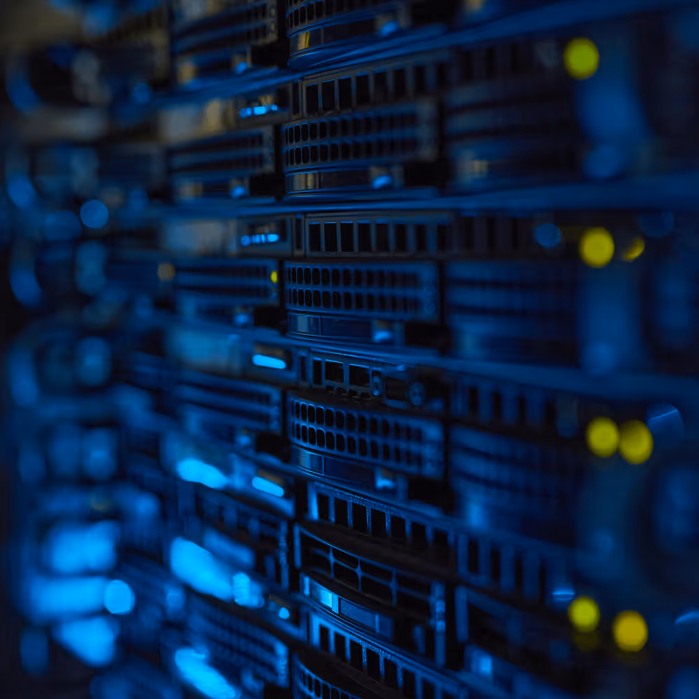 Close-up of server rack hardware with blue lighting and yellow indicator lights in data center.