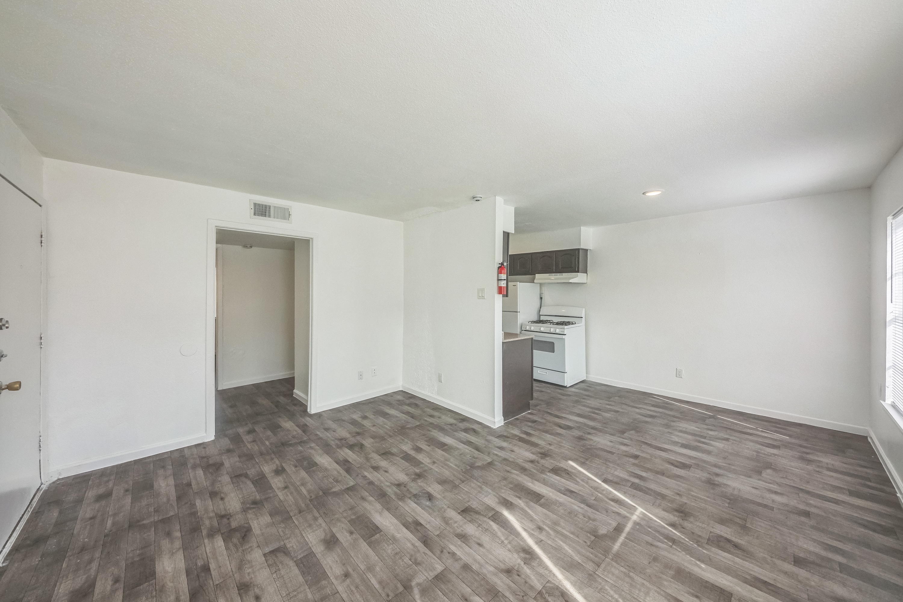 Living room and dining room with view of kitchen