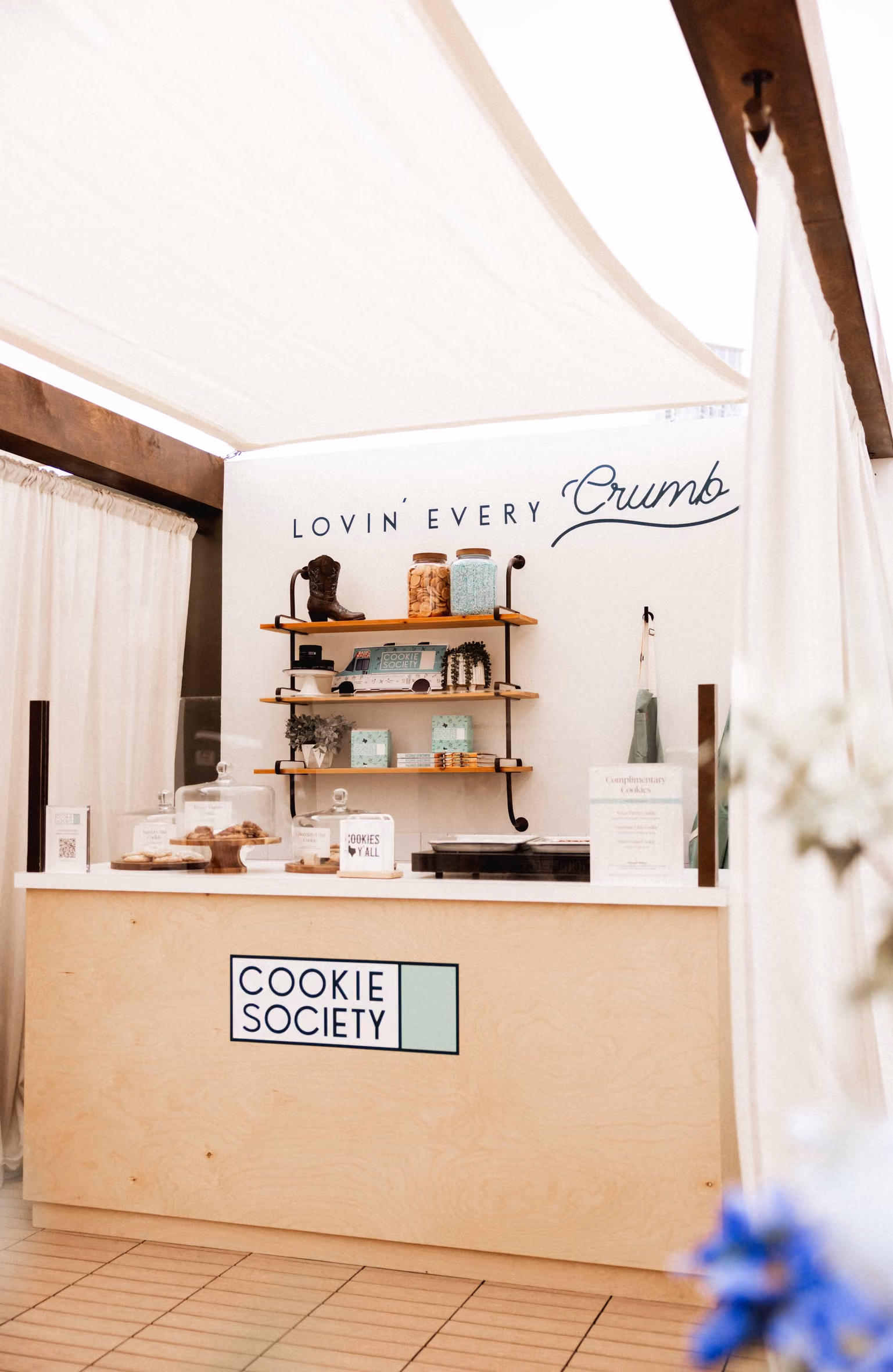 Cookie Society shop counter under a 'Lovin' every crumb' sign