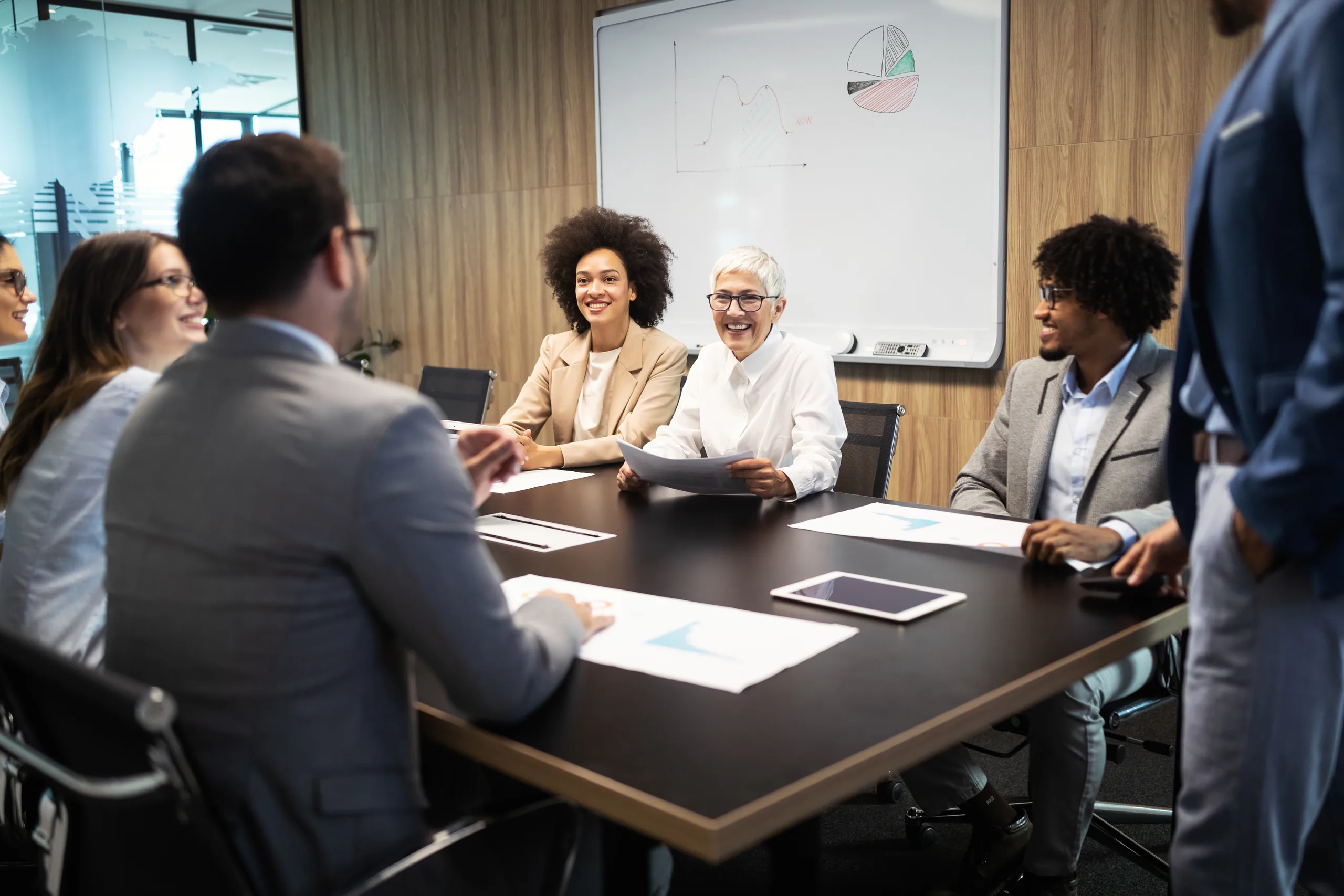 Group of business professionals collaborating in a busy open-plan office
